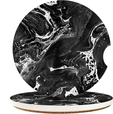 A pair of round black marble patterned ceramic stone car coasters with a cork base, designed to fit vehicle cupholders.