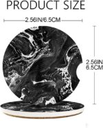 A pair of round black marble patterned ceramic stone car coasters with a cork base, designed to fit vehicle cupholders.