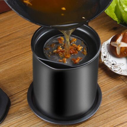Black Cambom bacon grease container with a fine mesh strainer and a black coaster tray, on a white background.