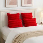 Two red faux rabbit fur throw pillow covers with a striped pattern, positioned on a neutral background.
