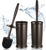 Two HAMITOR modern bronze toilet brushes with their matching round holders, standing upright on a bathroom floor.