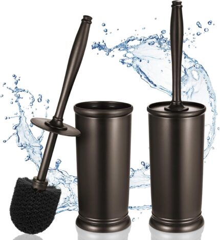 Two HAMITOR modern bronze toilet brushes with their matching round holders, standing upright on a bathroom floor.