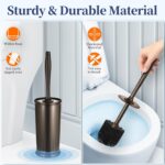 Two HAMITOR modern bronze toilet brushes with their matching round holders, standing upright on a bathroom floor.