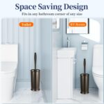 Two HAMITOR modern bronze toilet brushes with their matching round holders, standing upright on a bathroom floor.