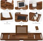 Kiasthome expandable teak wood bathtub caddy tray in dark natural teak, holding a book, wine glass, and soap.