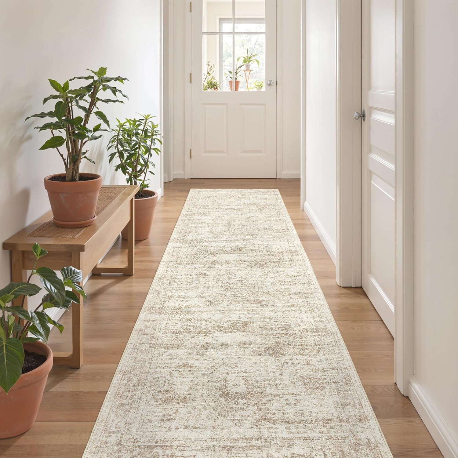 restydon-2x8-runner-rug-washable-non-slip-hallway-carpet-beige-ivory-01 A beige/ivory Restydon 2x8 runner rug with a subtle pattern, laid out on a floor in an indoor setting.