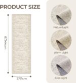 A beige/ivory Restydon 2x8 runner rug with a subtle pattern, laid out on a floor in an indoor setting.