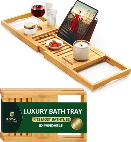 ROYAL CRAFT WOOD Premium Foldable Bathtub Tray Caddy in natural bamboo, holding a book, wine glass, and candle.