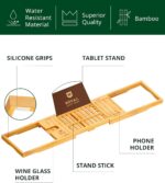 ROYAL CRAFT WOOD Premium Foldable Bathtub Tray Caddy in natural bamboo, holding a book, wine glass, and candle.