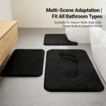 Three-piece RUN HELIX black memory foam bath rug set on a tile floor, showing large, small, and U-shape mats.