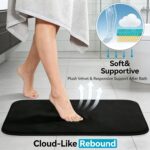 Three-piece RUN HELIX black memory foam bath rug set on a tile floor, showing large, small, and U-shape mats.