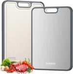 A sleek, silver rectangular Sumzzz titanium cutting board with a juice groove and garlic grinding area, shown on a kitchen co