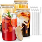 Four clear 16 oz sungwoo glass cups with bamboo lids and reusable straws, arranged neatly on a surface.
