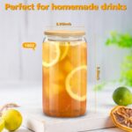 Four clear 16 oz sungwoo glass cups with bamboo lids and reusable straws, arranged neatly on a surface.