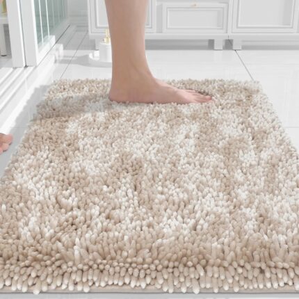A rectangular Yimobra Khaki Chenille Bath Mat, thick and fluffy, placed on a light-colored bathroom floor.