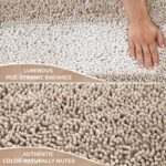 A rectangular Yimobra Khaki Chenille Bath Mat, thick and fluffy, placed on a light-colored bathroom floor.