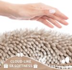 A rectangular Yimobra Khaki Chenille Bath Mat, thick and fluffy, placed on a light-colored bathroom floor.
