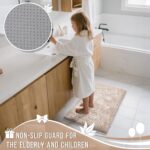 A rectangular Yimobra Khaki Chenille Bath Mat, thick and fluffy, placed on a light-colored bathroom floor.