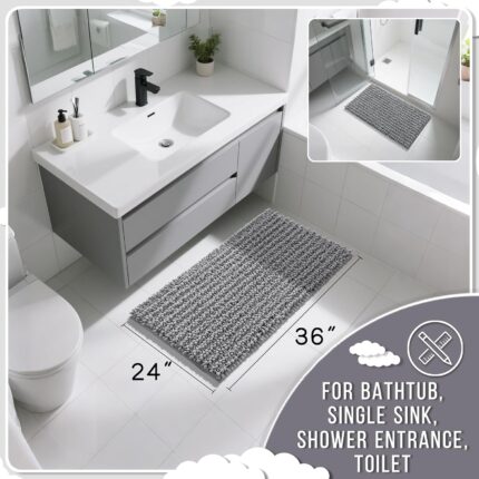A soft, rectangular grey chenille bath mat with a shaggy texture, placed on a clean bathroom floor.