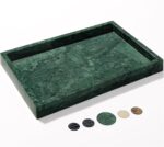 A rectangular dark green natural marble vanity tray, polished and smooth, on a light surface, showcasing its unique veining.