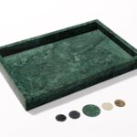 A rectangular dark green natural marble vanity tray, polished and smooth, on a light surface, showcasing its unique veining.