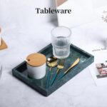 A rectangular dark green natural marble vanity tray, polished and smooth, on a light surface, showcasing its unique veining.