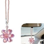 A vibrant Zigeiya pink crystal 3D flower charm hanging, reflecting colorful light against a soft background.