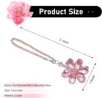 A vibrant Zigeiya pink crystal 3D flower charm hanging, reflecting colorful light against a soft background.