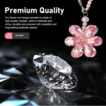 A vibrant Zigeiya pink crystal 3D flower charm hanging, reflecting colorful light against a soft background.