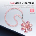 A vibrant Zigeiya pink crystal 3D flower charm hanging, reflecting colorful light against a soft background.